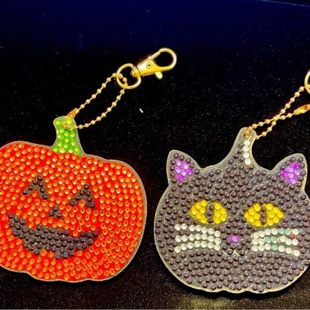 Halloween sparkling key chains or purse accessories. A black cat and a pumpkin